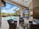 Screened lanai with comfortable seating overlooks a sparkling pool and fountain with golf course views at 3400 Park Grove Ct, Longwood, FL 32779