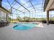 Tranquil screened-in pool with spa, well-maintained concrete, and two tables with seating for four at 3400 Park Grove Ct, Longwood, FL 32779