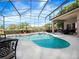 Sparkling screened-in pool with attached spa surrounded by lush green landscaping and outdoor seating at 3400 Park Grove Ct, Longwood, FL 32779