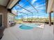 Beautiful screened-in pool with a spa, mature landscaping, and seating surrounded by concrete at 3400 Park Grove Ct, Longwood, FL 32779