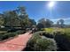 Picturesque community park with walking bridge, lush landscaping, and a playground visible in the background at 437 Wilmington Cir, Oviedo, FL 32765