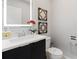 Stylish half bathroom features a sleek vanity, modern fixtures, and decorative wall art at 4445 Le Reve Ct, Kissimmee, FL 34746