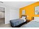 Inviting bedroom featuring twin beds, a bright accent wall, and a closet for storage at 4445 Le Reve Ct, Kissimmee, FL 34746