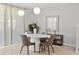 Bright dining area features a modern white table set, contemporary lighting, and stylish decor at 4445 Le Reve Ct, Kissimmee, FL 34746