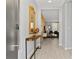 Inviting entryway with a console table, decorative mirror, and open view into the living area at 4445 Le Reve Ct, Kissimmee, FL 34746