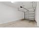 Spacious and clean one car garage with concrete floors and white block walls at 4445 Le Reve Ct, Kissimmee, FL 34746