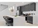 Contemporary kitchen featuring dark cabinets, white countertops, and stainless steel appliances at 4445 Le Reve Ct, Kissimmee, FL 34746