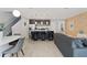 Inviting open-concept living area with a sleek kitchen island, modern furnishings, and a warm brick accent wall at 4445 Le Reve Ct, Kissimmee, FL 34746
