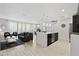 Bright, open-concept living space flows into the kitchen and dining area, perfect for entertaining at 4445 Le Reve Ct, Kissimmee, FL 34746
