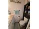 Bathroom featuring a vanity with a granite countertop, storage cabinet, toilet, and wood-look flooring at 4798 Windwood Dr, Kissimmee, FL 34746