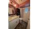 Cozy bathroom featuring a white vanity with granite countertop, wood flooring, and a shower-tub combo at 4798 Windwood Dr, Kissimmee, FL 34746
