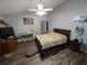 Spacious bedroom featuring wood floors, ceiling fan, and neutral paint at 4798 Windwood Dr, Kissimmee, FL 34746