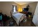 Bedroom featuring a bed with a metal frame, a window with curtains, and wood-look flooring at 4798 Windwood Dr, Kissimmee, FL 34746