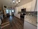 Modern kitchen with stainless appliances, stylish backsplash, ample cabinet space, and wood floors at 4798 Windwood Dr, Kissimmee, FL 34746
