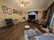 Cozy living room with wood floors, vaulted ceiling, and a comfortable seating area at 4798 Windwood Dr, Kissimmee, FL 34746
