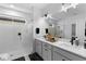 Modern bathroom with double vanity, white countertops and matte black hardware and accessories at 4911 Shady Pines Dr, St Cloud, FL 34772