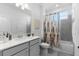 Bathroom featuring a shower-tub combo, a grey geometric shower curtain, and white vanity at 4911 Shady Pines Dr, St Cloud, FL 34772