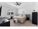 Tranquil bedroom with tray ceilings, a ceiling fan, and a calming color scheme at 4911 Shady Pines Dr, St Cloud, FL 34772