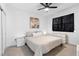 Modern bedroom featuring a ceiling fan, neutral color palette, and window with blackout curtains at 4911 Shady Pines Dr, St Cloud, FL 34772