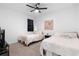 Bedroom featuring two twin beds, ceiling fan and a window with blackout curtains at 4911 Shady Pines Dr, St Cloud, FL 34772