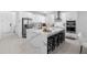 A modern kitchen with stainless steel appliances, a center island, and white cabinetry at 4911 Shady Pines Dr, St Cloud, FL 34772