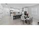 A modern kitchen with stainless steel appliances, a center island, white cabinetry, and a dining area at 4911 Shady Pines Dr, St Cloud, FL 34772
