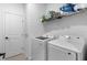 Bright laundry room with modern washer and dryer and shelving at 4911 Shady Pines Dr, St Cloud, FL 34772