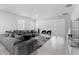 Modern living room with stylish gray sectional sofa and large windows for natural lighting at 4911 Shady Pines Dr, St Cloud, FL 34772