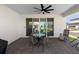 A covered patio with outdoor seating, a ceiling fan, and sliding glass doors at 4911 Shady Pines Dr, St Cloud, FL 34772