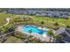 Aerial view of a community pool, playground, landscaping and homes surrounded by walking paths at 5251 Meredrew Ln, St Cloud, FL 34771