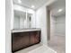 Bathroom vanity has dual mirrors, granite countertops and leads to closet at 5251 Meredrew Ln, St Cloud, FL 34771