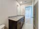Bathroom features a dark vanity, granite countertop and a large mirror at 5251 Meredrew Ln, St Cloud, FL 34771