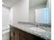 Bathroom featuring a white granite countertop, dark cabinets, and white tile in the shower at 5251 Meredrew Ln, St Cloud, FL 34771