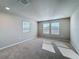 Sunlit bedroom with carpet, neutral walls, and multiple windows at 5251 Meredrew Ln, St Cloud, FL 34771