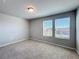 Comfortable bedroom featuring neutral carpet, two windows, and a ceiling light at 5251 Meredrew Ln, St Cloud, FL 34771