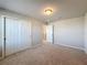 Carpeted bedroom with built in wardrobe, access to hallway and a ceiling light at 5251 Meredrew Ln, St Cloud, FL 34771