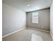 Clean and spacious bedroom with tile flooring, a window, and neutral paint, awaiting personalized touches at 5251 Meredrew Ln, St Cloud, FL 34771