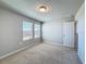 Cozy bedroom with neutral carpet, two windows letting in natural light and a ceiling fan at 5251 Meredrew Ln, St Cloud, FL 34771