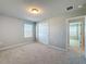 Bright carpeted bedroom features built in wardrobe, window and access to hallway at 5251 Meredrew Ln, St Cloud, FL 34771