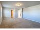 Well-lit bedroom showcases neutral paint, carpet, and doors to other rooms at 5251 Meredrew Ln, St Cloud, FL 34771