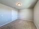 Bedroom with plush carpet, overhead lighting, and a built-in closet at 5251 Meredrew Ln, St Cloud, FL 34771