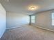 Bright bedroom with carpet, neutral walls, and natural light through windows at 5251 Meredrew Ln, St Cloud, FL 34771