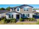 Charming two-story home featuring a landscaped yard, neutral color palette and inviting covered entryway at 5251 Meredrew Ln, St Cloud, FL 34771