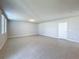 Spacious living room with neutral walls and tile flooring and abundant natural light from the large window at 5251 Meredrew Ln, St Cloud, FL 34771