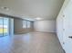 Bright and airy living area with tiled floors, sliding glass doors to the yard, and neutral color scheme at 5251 Meredrew Ln, St Cloud, FL 34771