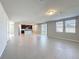 Bright, open-concept living space featuring tile floors, leading to a kitchen and sliding glass doors at 5251 Meredrew Ln, St Cloud, FL 34771