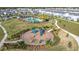 Overhead view of a colorful community playground with slides and swings, surrounded by walking trails at 5251 Meredrew Ln, St Cloud, FL 34771