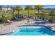 Close-up of the community pool with chairs, tables, and lush landscaping providing a resort-like experience at 5251 Meredrew Ln, St Cloud, FL 34771