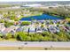 Aerial view of the neighborhood, showing the lake and homes with lush landscaping at 543 Flower Fields Ln, Orlando, FL 32824