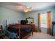 Cozy bedroom with a ceiling fan, window with blinds, and traditional wooden furniture at 543 Flower Fields Ln, Orlando, FL 32824